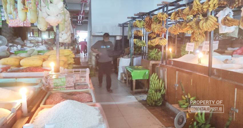 Pedagang di pasar sentral yang saat ini hanya menggunakan lilin sebagai lampu penerangan setelah tiga hari lamanya pusat perdagangan di Kota Gorontalo itu tidak ada pasokan listrik. (Foto: Roy/Gorontalo Post)